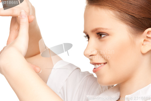 Image of lovely woman creating a frame with fingers