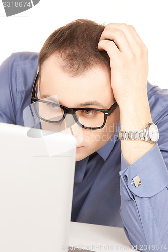 Image of businessman with laptop computer in office