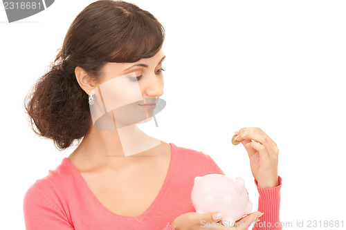 Image of lovely woman with piggy bank and money