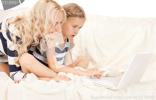 Image of happy mother and child with laptop computer