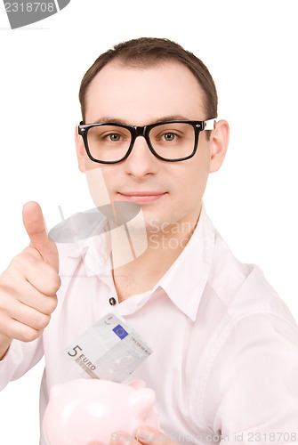 Image of businessman with piggy bank and money