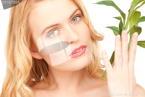 Image of woman with sprout over white