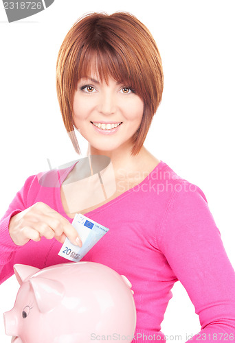 Image of lovely woman with piggy bank and money