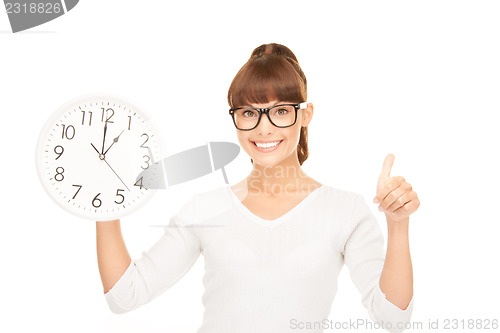 Image of woman holding big clock