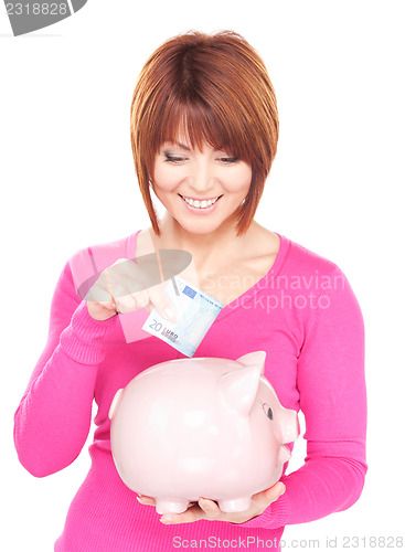 Image of lovely woman with piggy bank and money