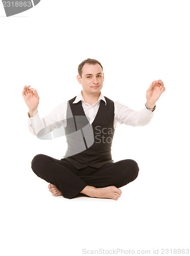 Image of businessman sitting in lotus pose