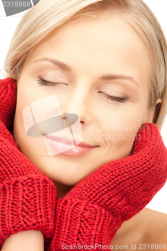 Image of beautiful woman in red mittens 