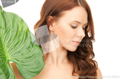 Image of woman with green leaf