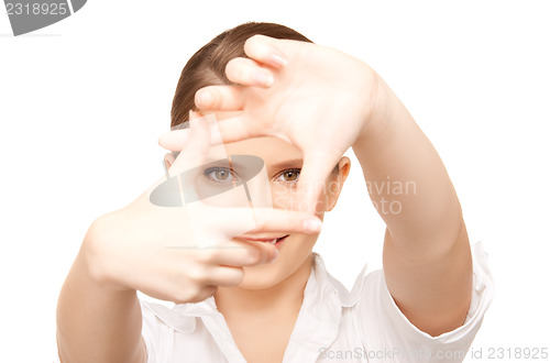Image of lovely woman creating a frame with fingers