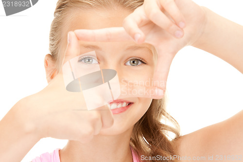 Image of pretty girl creating a frame with fingers