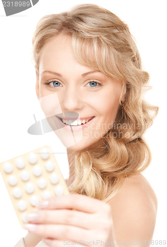 Image of young woman with pills