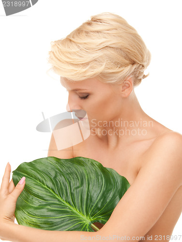 Image of woman with green leaf