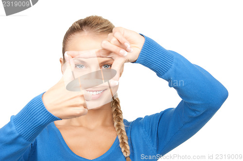 Image of lovely woman creating a frame with fingers