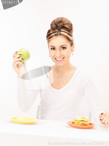 Image of woman with green apple and sandwich