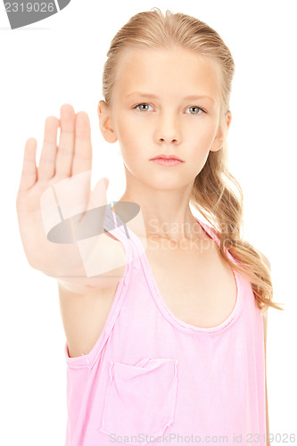 Image of lovely girl showing stop sign