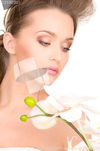 Image of beautiful woman with white flower