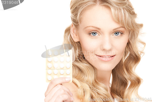 Image of young woman with pills