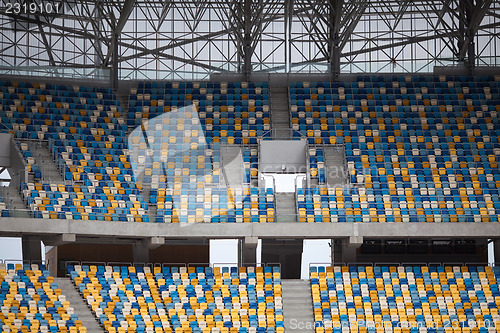 Image of Tiered seats sit empty in large sports stadium