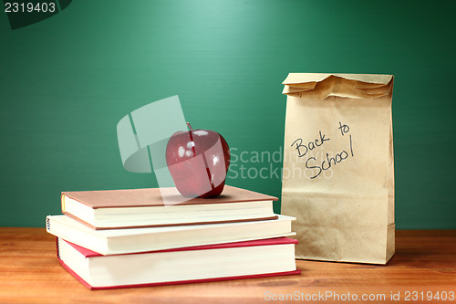 Image of Books, Apple and Lunch on Teacher Desk