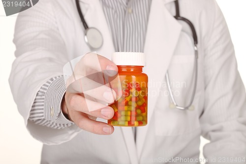 Image of Doctor With Medication in Prescription Bottles