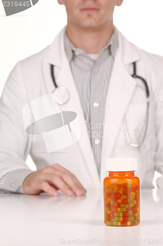 Image of Doctor With Medication in Prescription Bottles