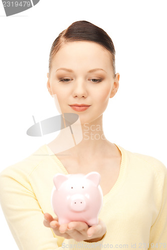 Image of  lovely woman with piggy bank	 