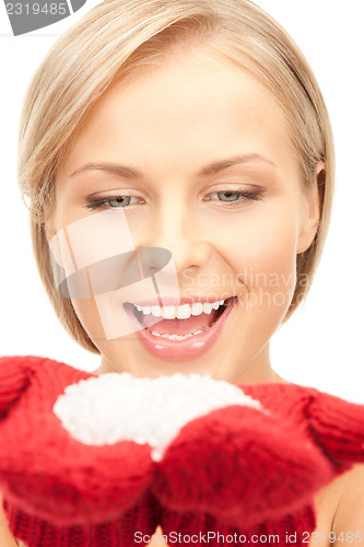 Image of beautiful woman in red mittens with snow