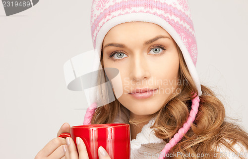 Image of beautiful woman with red mug