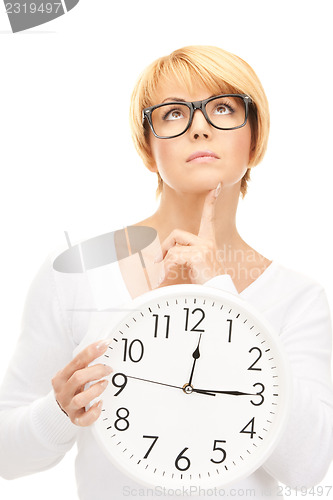 Image of woman holding big clock