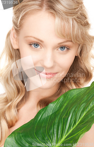 Image of woman with green leaf