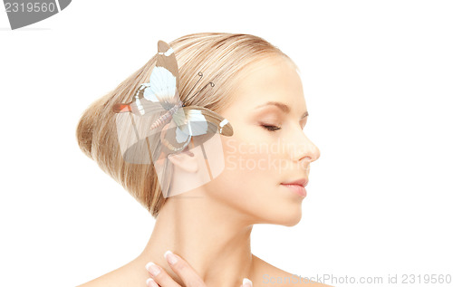 Image of beautiful woman with butterfly in hair