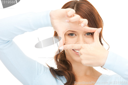 Image of lovely woman creating a frame with fingers