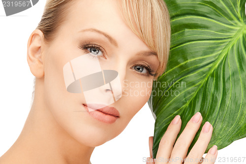 Image of woman with green leaf