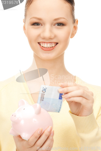 Image of lovely woman with piggy bank 
