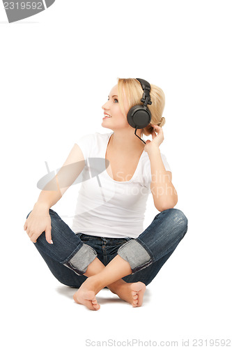 Image of  happy teenage girl in big headphones