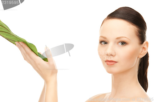 Image of woman with green leaf