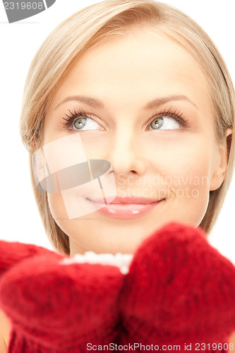 Image of beautiful woman in red mittens with snow