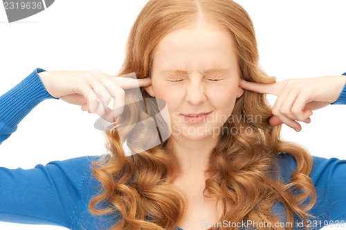 Image of woman with fingers in ears