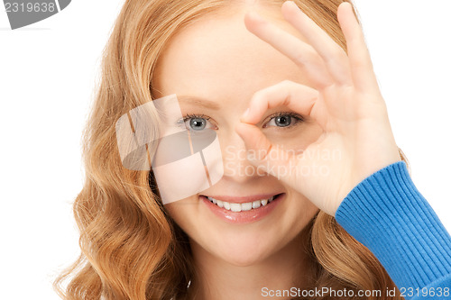 Image of lovely woman looking through hole from fingers