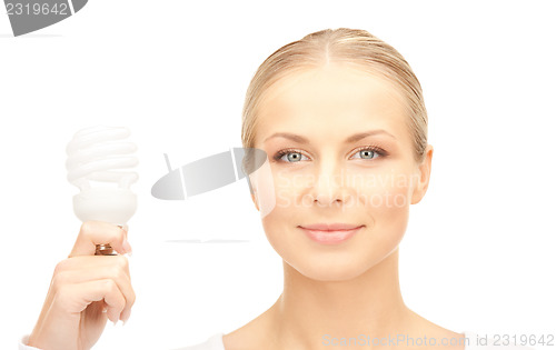 Image of woman holding energy saving bulb