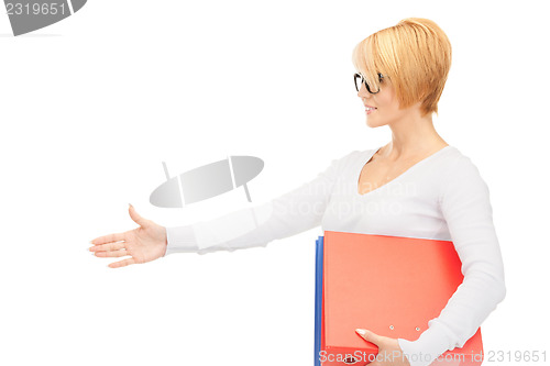 Image of businesswoman with folders ready for handshake