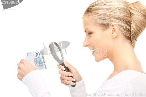 Image of woman with magnifying glass and money