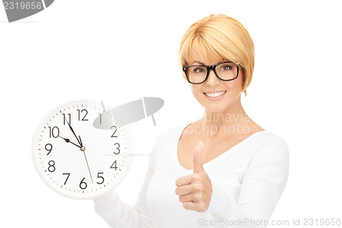 Image of woman holding big clock