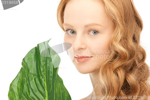 Image of woman with green leaf