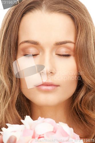 Image of beautiful woman with rose petals