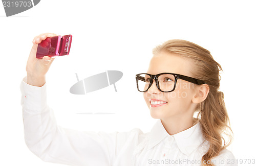 Image of happy girl taking picture with cell phone