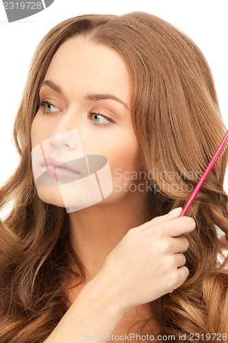 Image of beautiful woman with comb