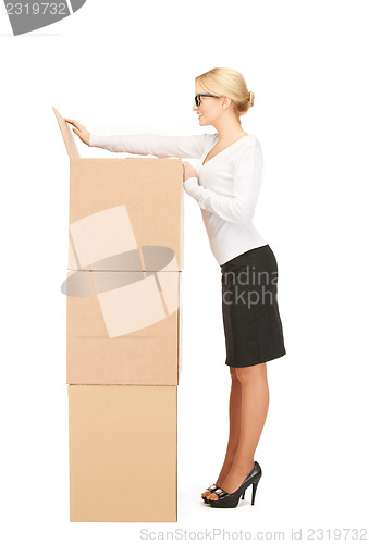 Image of  attractive businesswoman with big boxes	 