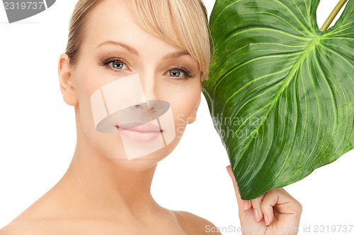 Image of woman with green leaf