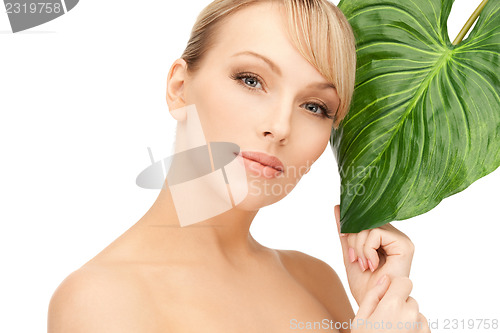 Image of woman with green leaf